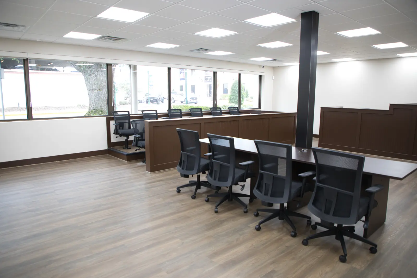 Mock Court Room in natural light — jury box along the windows, counsel tables, and a structural pillar